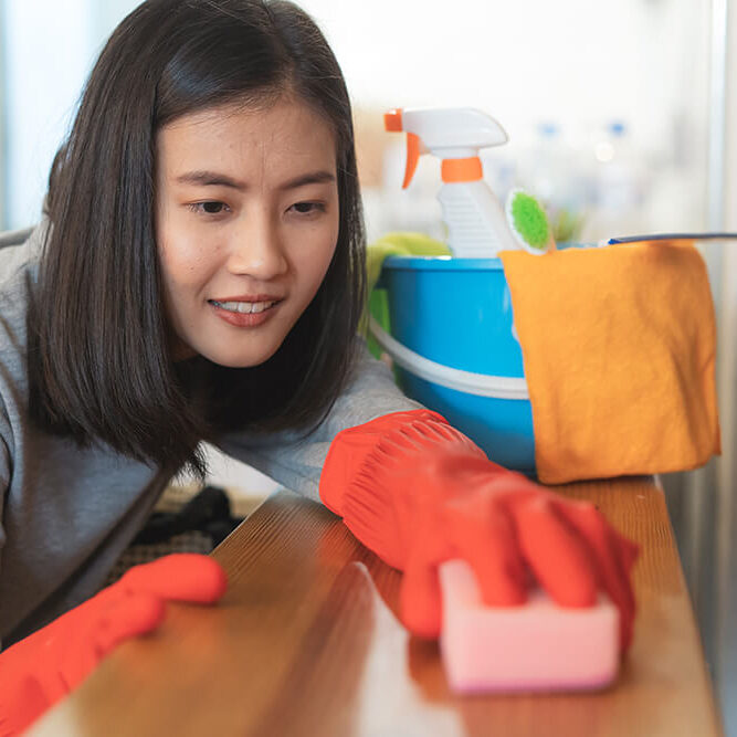close-up-woman-cleaning-kitchen-using-cleanser-spray-cloth