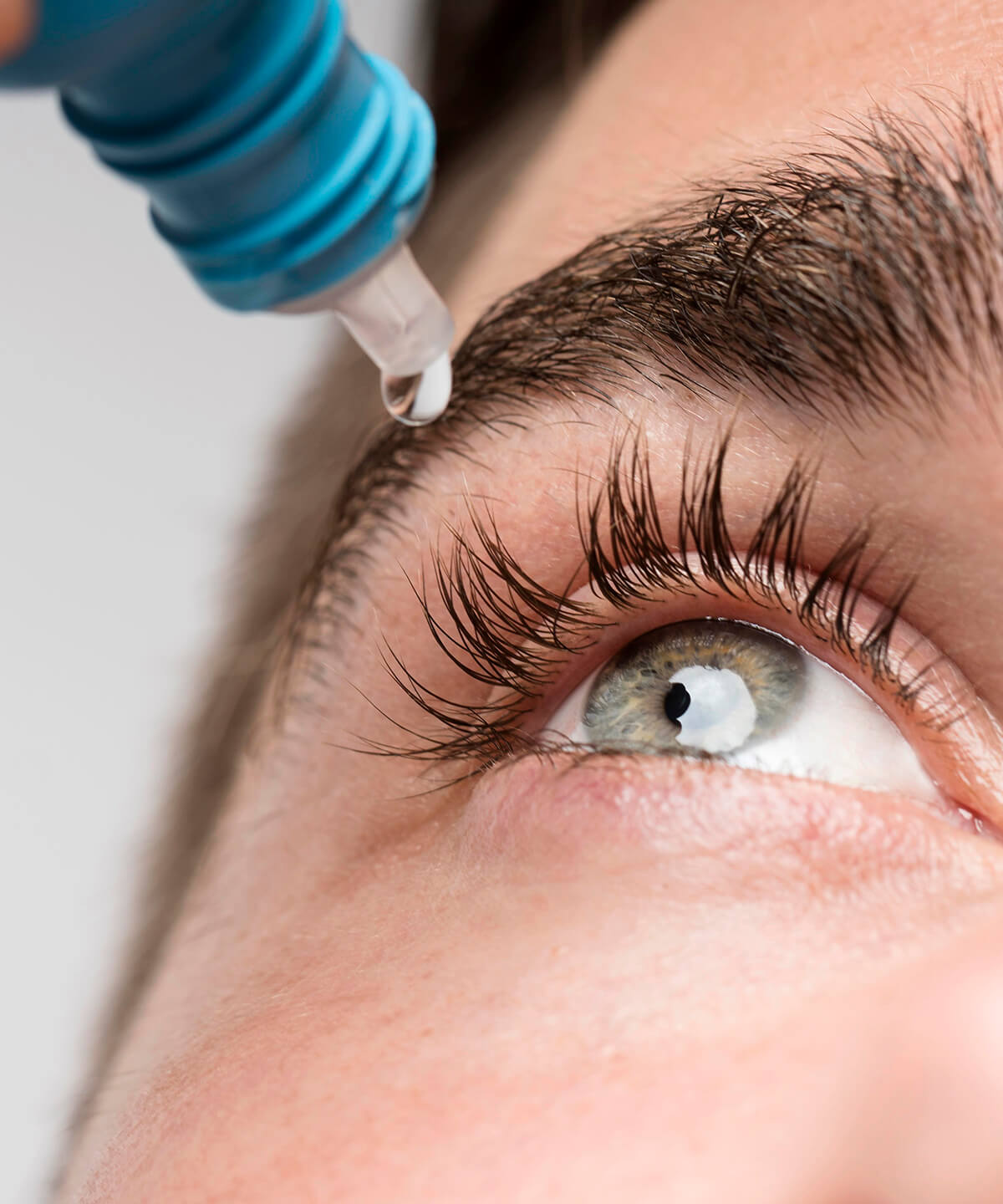 handsome-man-using-eye-drops-close-up
