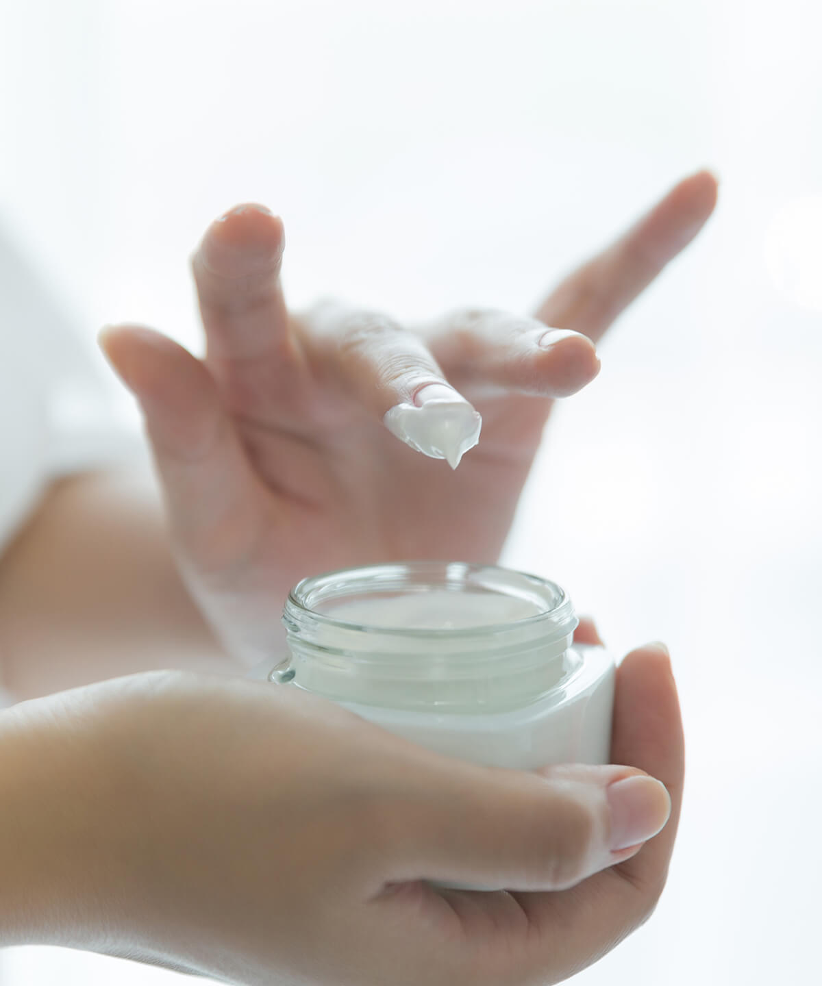 woman-holds-jar-with-cosmetic-cream-her-hands