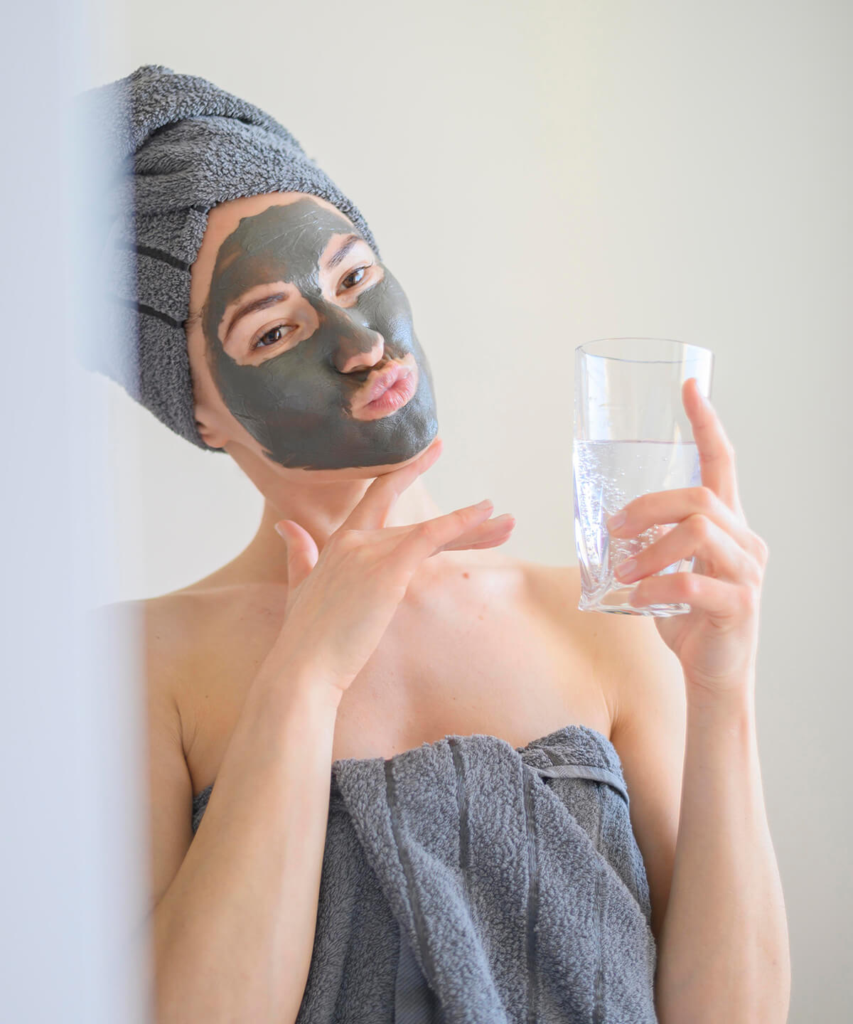 woman-wearing-face-mask-making-faces-mirror